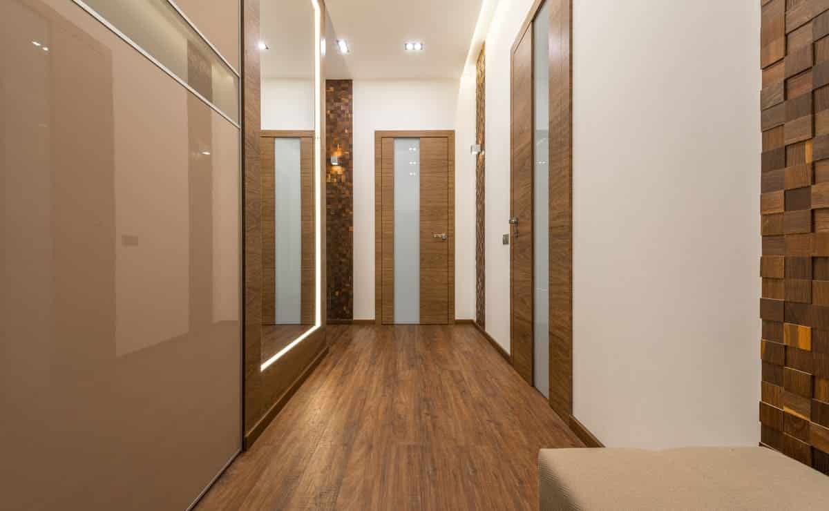 white minimalist home hallway|home hallway decorated with papale tapestry|home aisle with wood|hallway with stairs in your home