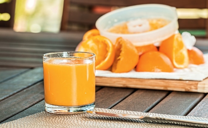 zumo de naranja recién exprimido en vaso de cristal