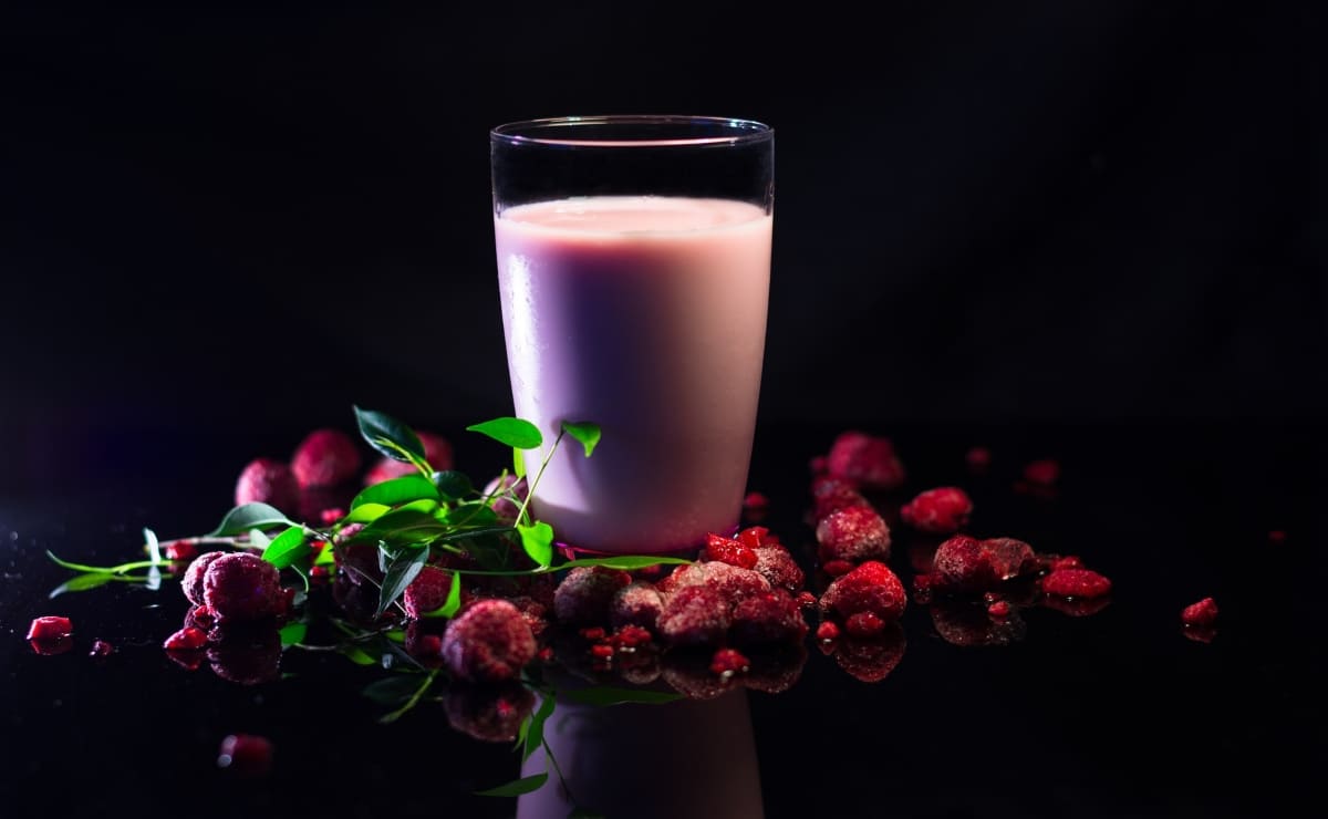 raspberry milkshake on a black table