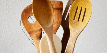 Close-up of various kitchen utensils made of wood.