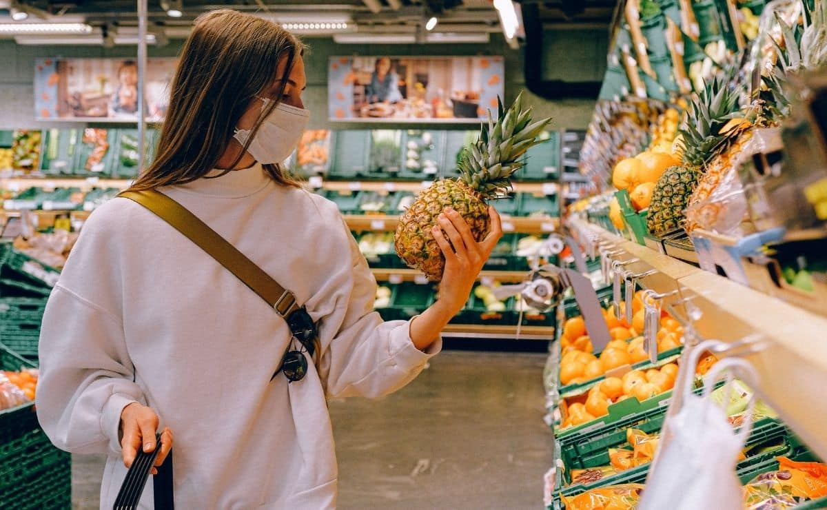 mujer comprando piña
