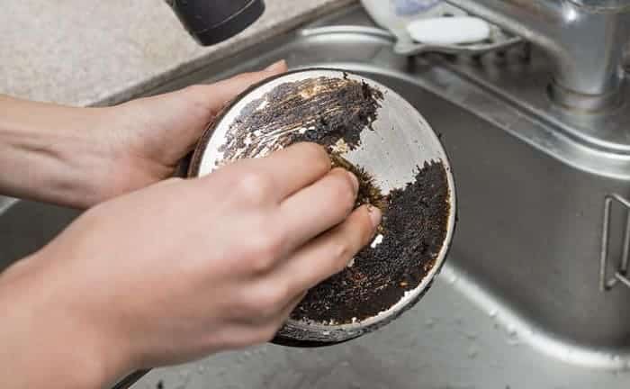 remove stuck-on debris from pots and pans bleach