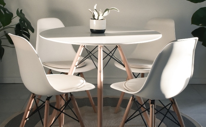 living room table and 4 white Scandinavian style chairs