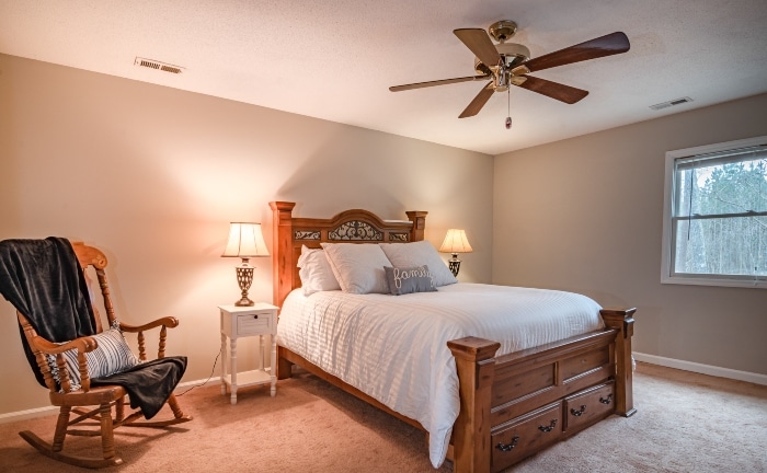 wooden fan with 3 blades in a bedroom
