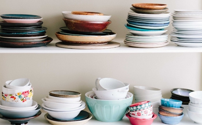 two shelves with varied and colorful crockery